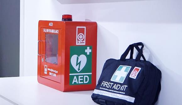 Defibrillator in red cabinet